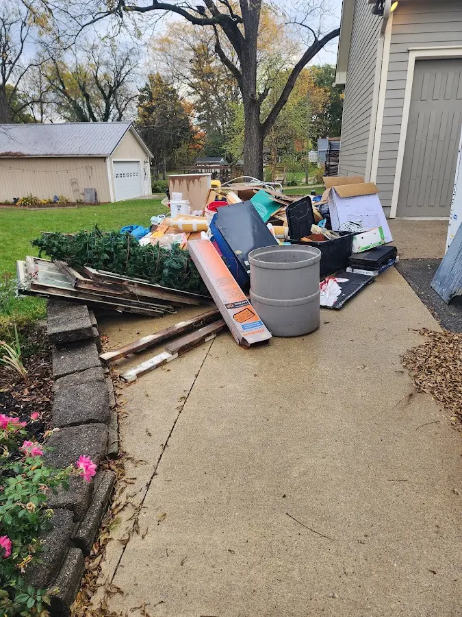 Dumpster being loaded with debris for 12 Yard Dumpster Rental in D'Iberville